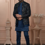 Man wearing navy Indo-Western with embroidered geometric patterned jacket.