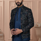 Man wearing navy Indo-Western with embroidered geometric patterned jacket.