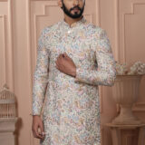 Man wearing pastel Indo-Western with intricate multicolor printed motifs.