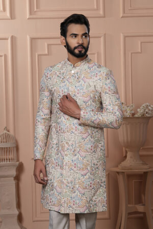 Man wearing pastel Indo-Western with intricate multicolor printed motifs.