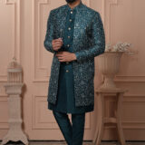 Man wearing teal Indo-Western with embroidered jacket and gold buttons.