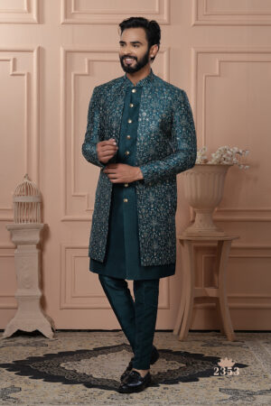 Man wearing teal Indo-Western with embroidered jacket and gold buttons.