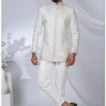 White Jodhpuri suit with silver geometric and floral embroidery.