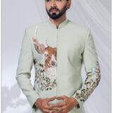 Sage green Jodhpuri with embroidered deer and floral motifs, paired with white bottoms.