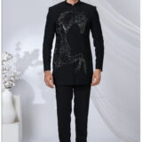 Man wearing a black Jodhpuri suit with an embroidered sequined horse design and mandarin collar.