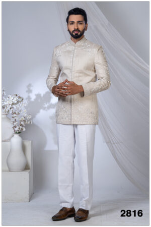 Man wearing an ivory Jodhpuri suit with pearl embroidery, floral motifs, and a mandarin collar.