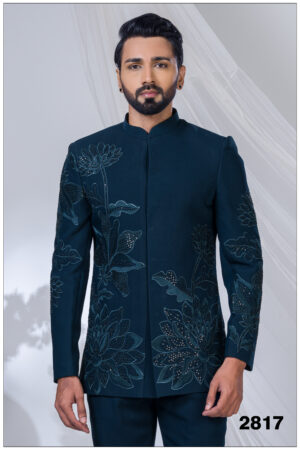 Man wearing a teal Jodhpuri suit with lotus embroidery, sequin detailing, and mandarin collar.