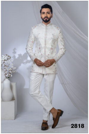 Man wearing an ivory Jodhpuri suit with pastel floral and geometric embroidery and a mandarin collar.