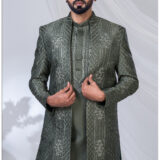 Man wearing an olive green open Indo Western sherwani with geometric embroidery and floral detailing.