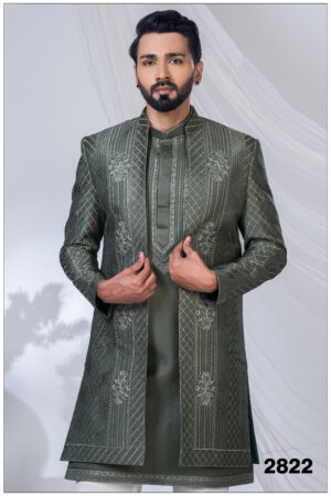 Man wearing an olive green open Indo Western sherwani with geometric embroidery and floral detailing.