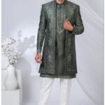 Man wearing an olive green open Indo Western sherwani with geometric embroidery and floral detailing.