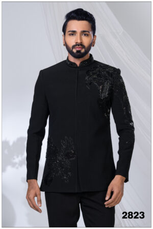 Man wearing a black Jodhpuri suit with intricate eagle motif embroidery on the chest and sleeve.