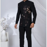 Man wearing a black Jodhpuri suit with embroidered horse and floral motifs in bronze shades.