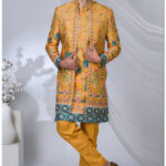 Man wearing a mustard Indo-Western outfit with floral multicolor prints and teal-red border accents.