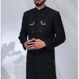 Man wearing a black Indo-Western sherwani with detailed black embroidery and beadwork.