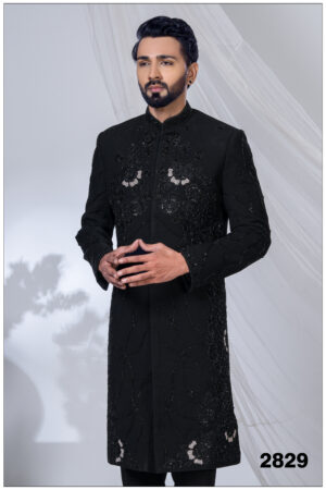 Man wearing a black Indo-Western sherwani with detailed black embroidery and beadwork.