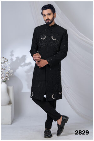 Man wearing a black Indo-Western sherwani with detailed black embroidery and beadwork.