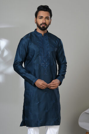 Men’s navy blue kurta with intricate embroidery and white trousers