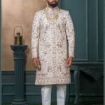 Ivory silk groom sherwani with peacock and elephant zari embroidery