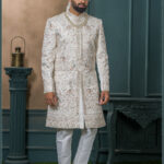 Ivory brocade groom sherwani with elephant and floral zari embroidery