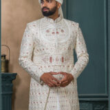 Ivory brocade sherwani with handcrafted elephant embroidery and detailed zari work for groom