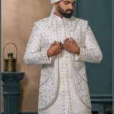 Ivory brocade sherwani with red and gold embroidery for groom wedding wear