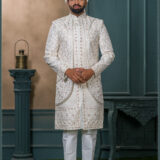 Ivory brocade sherwani with red and gold embroidery for groom wedding wear