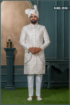 Ivory brocade sherwani with red and gold embroidery for groom wedding wear