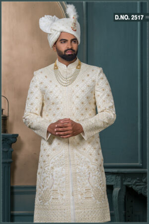 Ivory sherwani with gold embroidery and peacock design for groom wedding wear