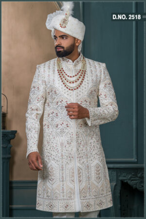 Ivory sherwani with geometric embroidery and red stone detailing for groom wedding wear