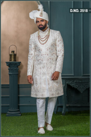 Ivory sherwani with geometric embroidery and red stone detailing for groom wedding wear