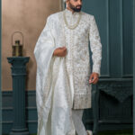 Ivory floral embroidered sherwani with golden zari work for groom wedding wear