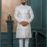 Ivory sherwani with silver and pastel embroidery featuring royal arch motifs, perfect for wedding wear.