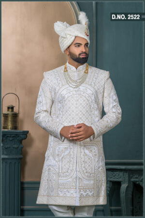Ivory sherwani with intricate golden geometric and arch embroidery, ideal for grooms seeking a royal traditional look.