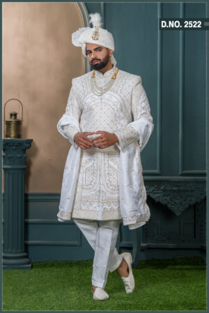 Ivory sherwani with intricate golden geometric and arch embroidery, ideal for grooms seeking a royal traditional look.