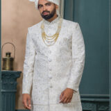 Ivory sherwani with mirror work and floral embroidery, designed for a royal groom look with subtle shimmer detailing.