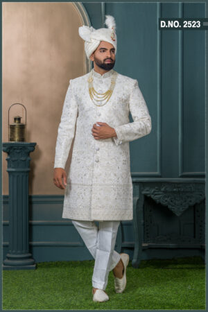 Ivory sherwani with mirror work and floral embroidery, designed for a royal groom look with subtle shimmer detailing.