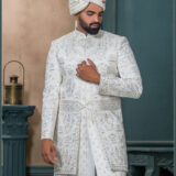 White embroidered sherwani with resham and mirror detailing, designed for a royal groom look.