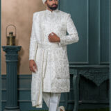 White embroidered sherwani with resham and mirror detailing, designed for a royal groom look.