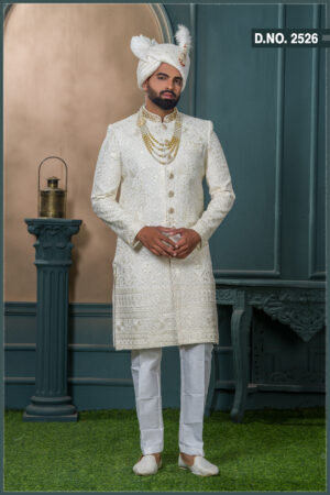 Ivory sherwani for groom with sequin and thread embroidery, paired with royal turban and pearl mala.